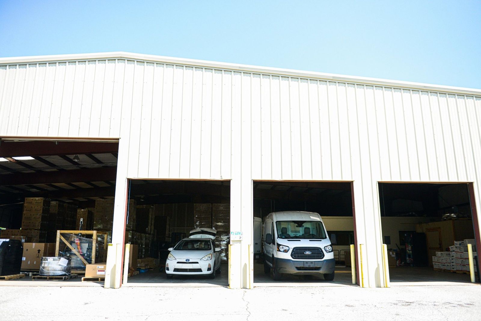 ACME warehouse bay doors in Greer, SC with a van and staged freight